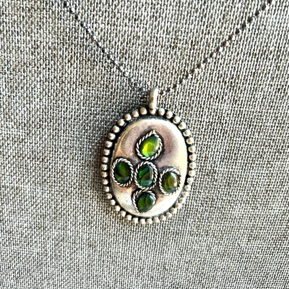 Silver pendant with matching necklace.